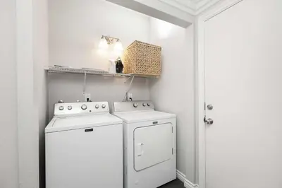 a white laundry room with a washer and dryer at Newport Retreat A - Fab for 4 in Newport Beach