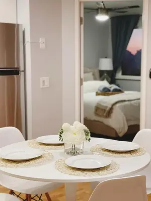 a table with plates and flowers on it in a bedroom at Bright & Quiet 1-Bed Condo with Balcony in San Diego