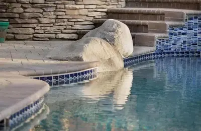 a pool of water with some rocks in the water at Serene hillside oasis with pool - 20 min to beach in Oceanside