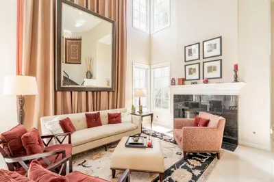a living room with a couch and a mirror at Luxe Family Villa ,116 inch Theater, Yard , Near Beaches in San Diego