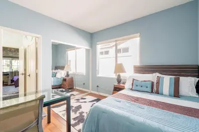 a bedroom with a bed and a glass table at Luxe Family Villa ,116 inch Theater, Yard , Near Beaches in San Diego