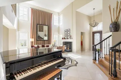 a living room with a piano and a fireplace at Luxe Family Villa ,116 inch Theater, Yard , Near Beaches in San Diego