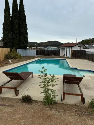 a swimming pool with two benches in front of it at Bella Vista Spacious 5-bed home with stunning mountain views and pool in Vista