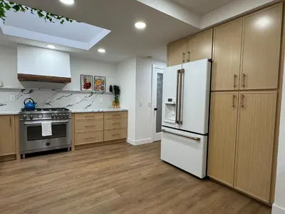 a kitchen with a white refrigerator and wooden cabinets at Bella Vista Spacious 5-bed home with stunning mountain views and pool in Vista