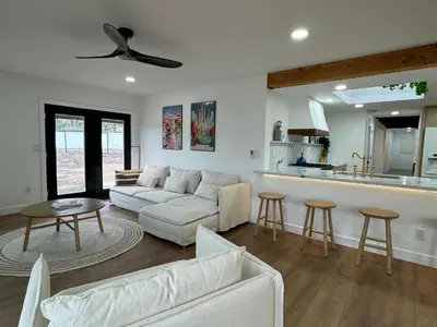 a living room with a white couch and a kitchen at Bella Vista Spacious 5-bed home with stunning mountain views and pool in Vista