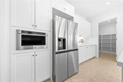 a kitchen with a stainless steel refrigerator and a microwave at Hidden Gem New 4B3B House UCI Disney Amazing view in Irvine