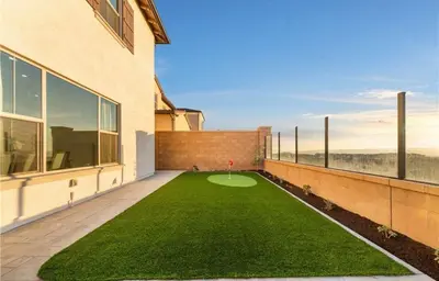 a balcony with a green lawn in front of a building at Hidden Gem New 4B3B House UCI Disney Amazing view in Irvine