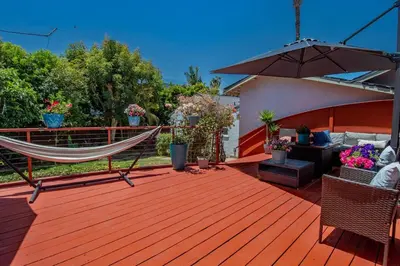 a hammock on the deck of a house at Ultimate Escape! Huge Yard Parking Walk to Beach in San Diego