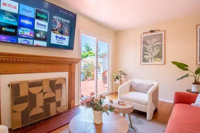 a living room with a fireplace and a flat screen tv at Ultimate Escape! Huge Yard Parking Walk to Beach in San Diego