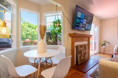 a living room with a table and chairs and a fireplace at Ultimate Escape! Huge Yard Parking Walk to Beach in San Diego