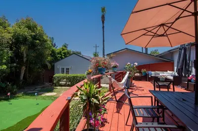 a patio with an umbrella and a table and chairs at Ultimate Escape! Huge Yard Parking Walk to Beach in San Diego