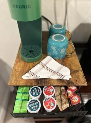 a wooden table with a green blender on top at Suite Steps to San Diego Top Spots in San Diego
