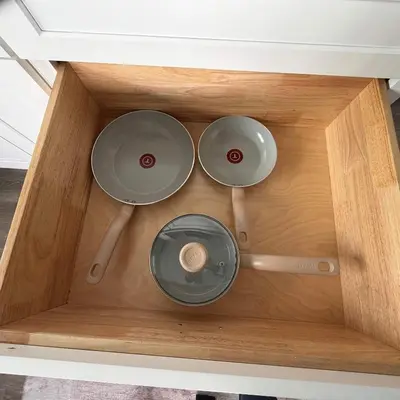 three pots and pans in a wooden drawer at Suite Steps to San Diego Top Spots in San Diego