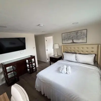a bedroom with a bed with two white shoes on it at Suite Steps to San Diego Top Spots in San Diego