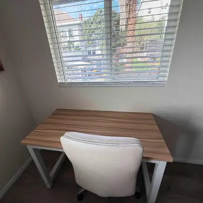 a wooden table with a white chair and a window at Suite Steps to San Diego Top Spots in San Diego