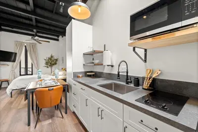 a kitchen with a sink and a table with a counter top at The Artifact Hotel in San Diego