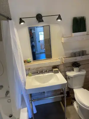 a bathroom with a sink and a toilet and a mirror at Scenic View Estate with Pool & Hot Tub in San Diego