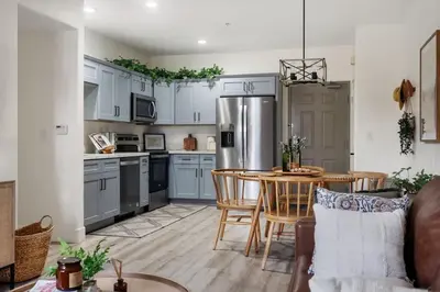 a kitchen with a table and a refrigerator at Down Town Condo with gym pool BBQ jacuzzi in San Diego