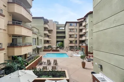 an apartment building with a swimming pool in a courtyard at Down Town Condo with gym pool BBQ jacuzzi in San Diego