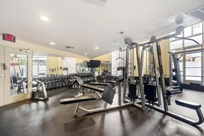 a gym with a bunch of treadmills and machines at Down Town Condo with gym pool BBQ jacuzzi in San Diego