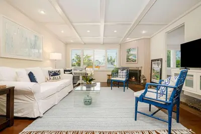 a living room with a white couch and blue chairs at La Jolla 3BR Oceanview Deck in San Diego