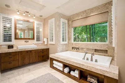 a bathroom with a tub and a sink and a window at La Jolla 3BR Oceanview Deck in San Diego