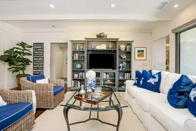 a living room with a white couch and a tv at La Jolla 3BR Oceanview Deck in San Diego