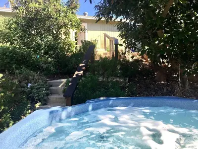 a hot tub in the yard of a house at Pet Friendly Breathtaking Cottage with Great Views and Hot-tub in Rainbow, California in Fallbrook
