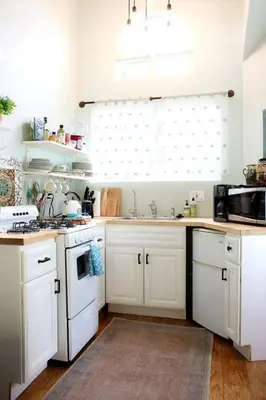 a kitchen with white cabinets and a sink at Pet Friendly Charming Cottage with Incredible Views and Hot-tub in Rainbow, California in Fallbrook