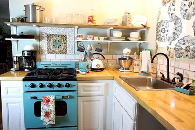 a kitchen with a blue stove and a sink at Pet Friendly Breathtaking Cottage with Hot-tub in Rainbow, California in Fallbrook