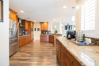 a large kitchen with wooden cabinets and a counter top at Temecula Wine Country Villa in Temecula