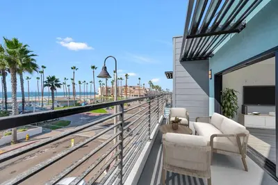 a balcony with a couch and a view of the beach at Steps to the Beach in Imperial Beach