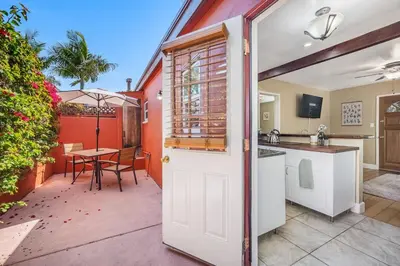 a kitchen and a patio with a table and a table at 1BD Heart of PB Pet Friendly Private Sanctuary in San Diego