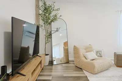 a living room with a couch and a large mirror at Immaculate Home near Balboa Park, SD Zoo, & Cafés in San Diego