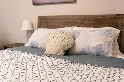 a bedroom with a bed with a wooden headboard at Central San Diego 3BR Home Near Beaches in San Diego