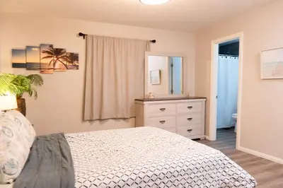 a bedroom with a bed and a dresser and a mirror at Central San Diego 3BR Home Near Beaches in San Diego