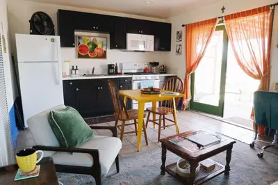 a living room with a table and a kitchen at Colorful Casita Frida 1BD Retreat by Balboa Park in San Diego