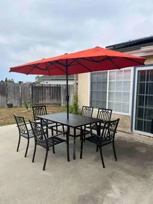 a table and chairs with a red umbrella at 15 Min from Torrey Pines State Beach and Golf in San Diego