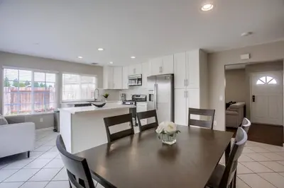 a kitchen and dining room with a table and chairs at 15 Min from Torrey Pines State Beach and Golf in San Diego