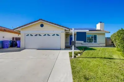 a house with a white garage in a yard at 15 Min from Torrey Pines State Beach and Golf in San Diego