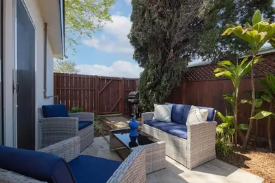 a patio with chairs and a table and a fence at 4 Miles to Beach Central and Newly Renovated in San Diego