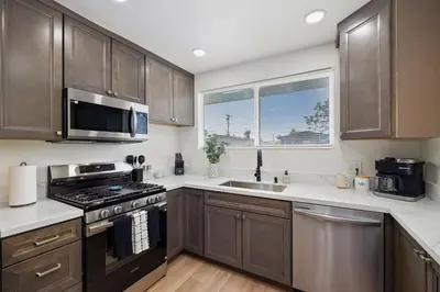 a kitchen with stainless steel appliances and a window at 4 Miles to Beach Central and Newly Renovated in San Diego