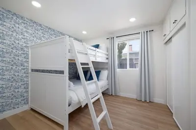 a bunk bed in a room with a ladder at 4 Miles to Beach Central and Newly Renovated in San Diego