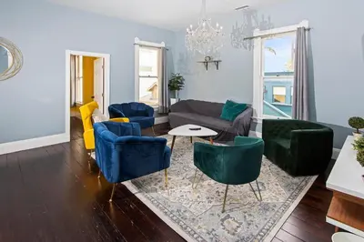 a living room with blue chairs and a couch at 1900's Victorian Home Sleeps 22 8BDRM 3Bath in San Diego