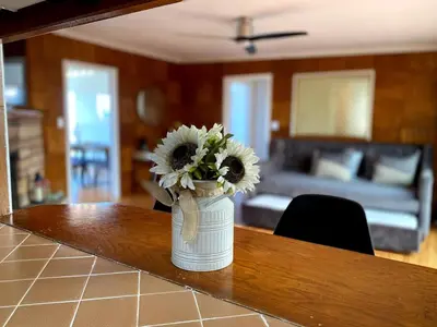 a vase filled with flowers sitting on a table at Hilltop Villa Offering Uninterrupted Ocean Vistas in San Diego