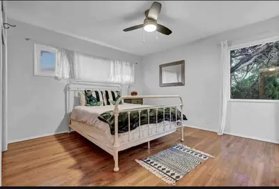 a bedroom with a bed and a ceiling fan at Hilltop Villa Offering Uninterrupted Ocean Vistas in San Diego