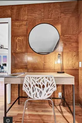a white chair sitting in front of a desk with a mirror at Hilltop Villa Offering Uninterrupted Ocean Vistas in San Diego