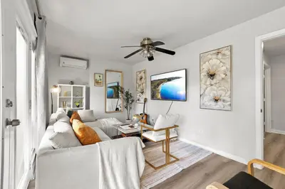 a living room with a white couch and a ceiling fan at Entire Private Home with 4 Bedrooms 3 Bathrooms, King Bed, Big Yard, Prime Area, Ranch Style, Available Now in La Mesa