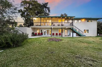 a large white house with a staircase in a yard at Entire Private Home with 4 Bedrooms 3 Bathrooms, King Bed, Big Yard, Prime Area, Ranch Style, Available Now in La Mesa