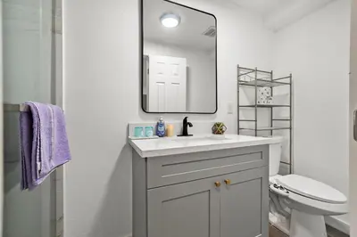 a white bathroom with a sink and a mirror at Entire Private Home with 4 Bedrooms 3 Bathrooms, King Bed, Big Yard, Prime Area, Ranch Style, Available Now in La Mesa